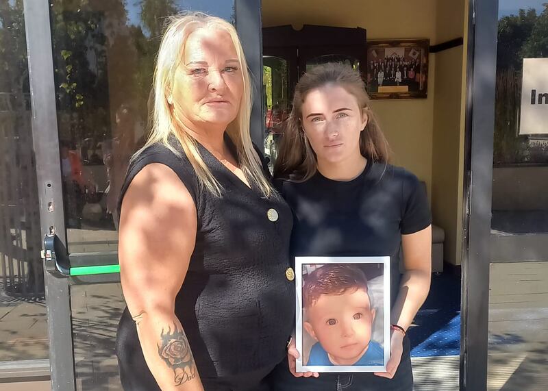 Mother Leanne Marshall (right) holding a photograph of her late son Christopher McDonagh-Marshall, accompanied by her mother Kelly, the boy's grandmother, outside Portaloise Coroner's Court at his inquest. Photograph: Mary Carolan