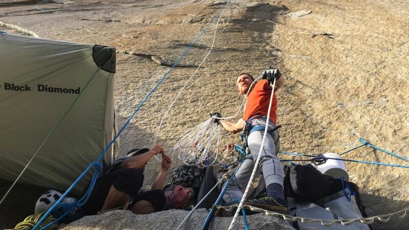 Tommy Caldwell hauls cable during a break in climbing the Dawn. The idea of free climbing the 3,000-foot rock formation — to use nothing but hands and feet to move upward, relying on ropes only to stop falls and pull equipment — was thought to be virtually impossible. Photograph: Big UP Productions/The New York Times