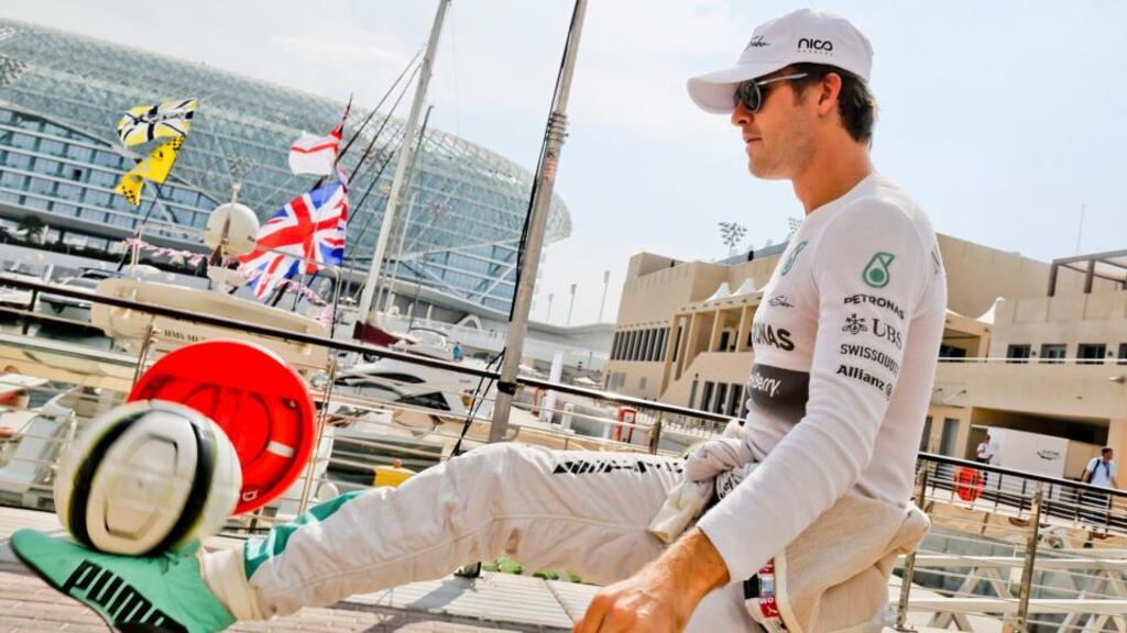Nico Rosberg of Mercedes AMG GP plays football at the paddock at Yas Marina Circuit in Abu Dhabi, United Arab Emirates. Photograph: Srd Jan Suki / EPA