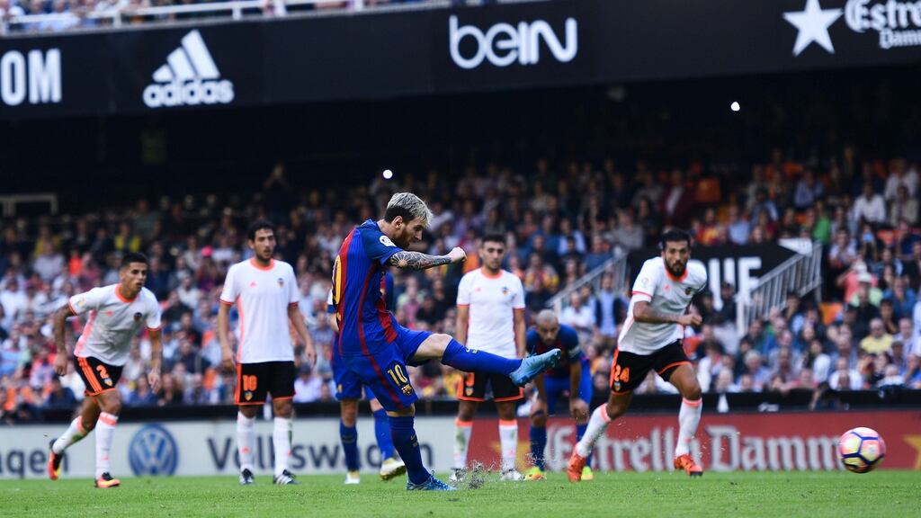 Lionel Messi of   Barcelona scores his team’s third from the penalty spot. Photo: David Ramos/Getty Images