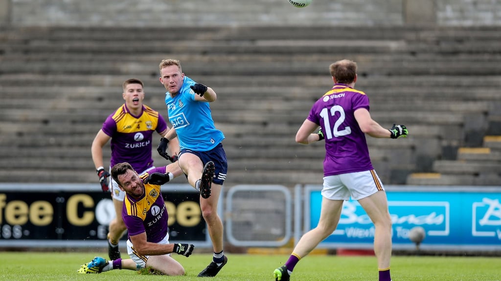 Wexford’s Dáithí Waters challenges Ciarán Kilkenny of Dublin during their Leinster SFC quarter-final. Photo: Tommy Dickson/Inpho