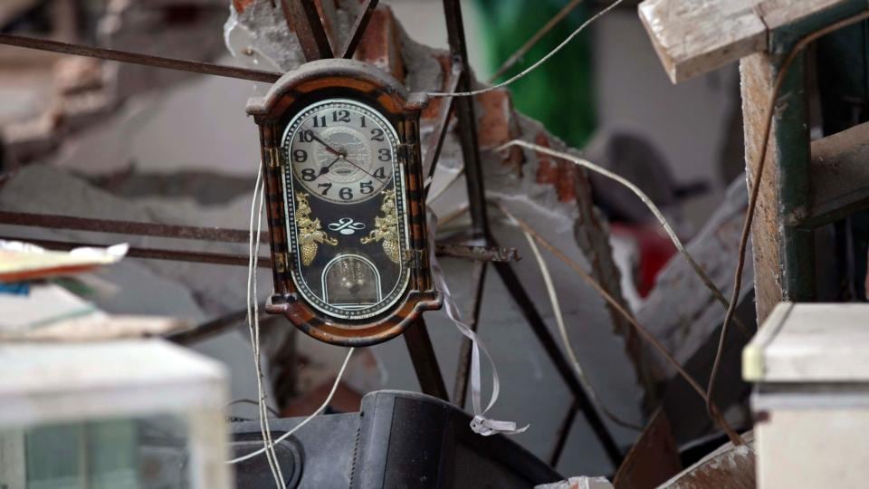 A clock is seen amidst the debris of a house that collapsed after a strong earthquake at Longmen village in China’s Sichuan province. Photograph: Reuters