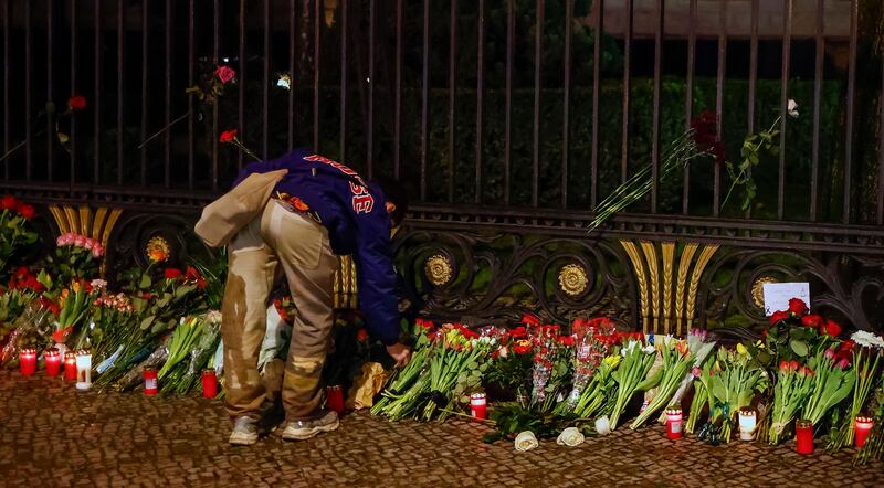 A man lays a flowers in memory of the victims of the terrorist attack on the Crocus City Hall in Krasnogorsk at the Russian embassy in Berlin, Germany. Photograph: Hannibal Hanschke/Shutterstock