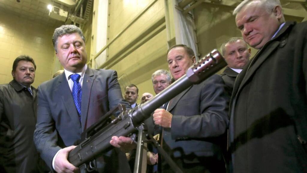 Ukraine’s president Petro Poroshenko holds a weapon at PA Yuzhmash aerospace enterprise in Dnipropetrovsk during the week. He has been urged to dismiss Ihor Kolomoisky. Photograph: Mykhailo Markiv/EPA