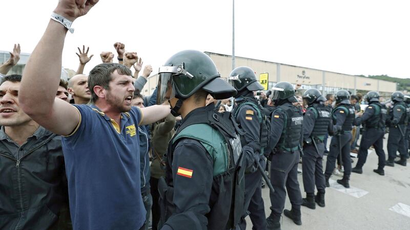 Officers of the Guardia Civil national police stand outside a polling centre at Sant Julia Sports Centre in Barcelona on Sunday. Photograph: Andreu Dalmau/EPA