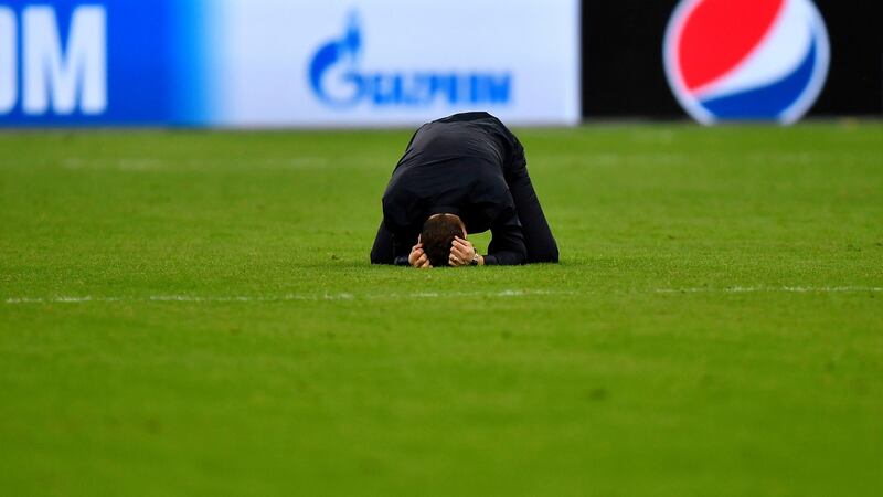 Pochettino buries his head in his hands on the pitch afterwards. Photo: Martin Meissner/AP Photo