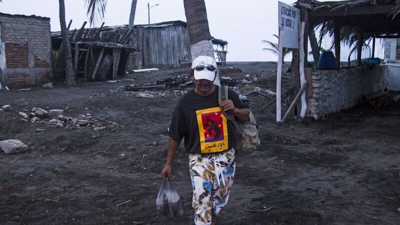 A man leaves his house in Boca de Pascuales, Colima State, Mexico,  before the arrival of Hurricane Patricia. Photograph: Hector Guerrero/AFP