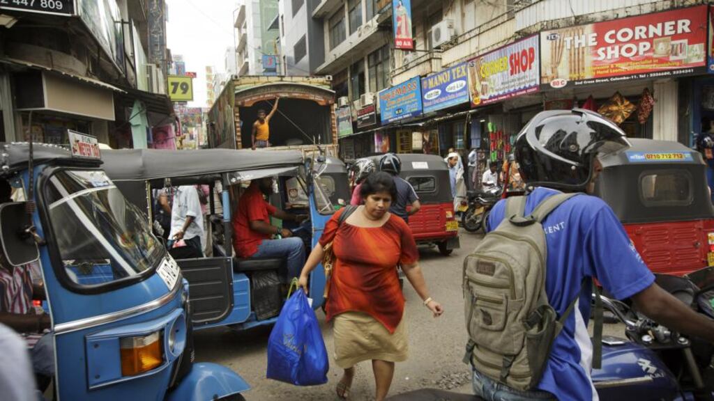 A city revived: Experience the merging of Sinhalese, Tamil and Muslim cultures in the tightly packed streets of Pettah, Colombo’s main market. Photograph: Kuni Takahashi for The New York Times