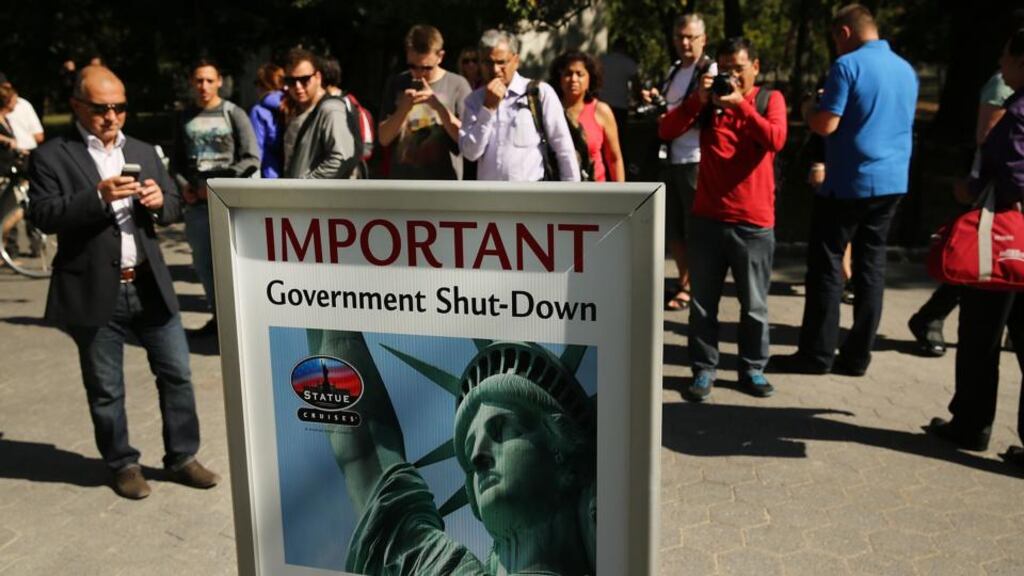 People look at a sign informing them that the Statue of Liberty is closed due to the government shutdown in Battery Park, New York yesterday. Photograph: Getty Images.