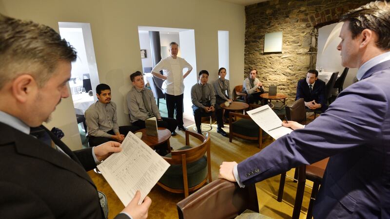 Darren Campbell (left), restaurant manager, and Danny Desmond general manager, during the daily staff briefing