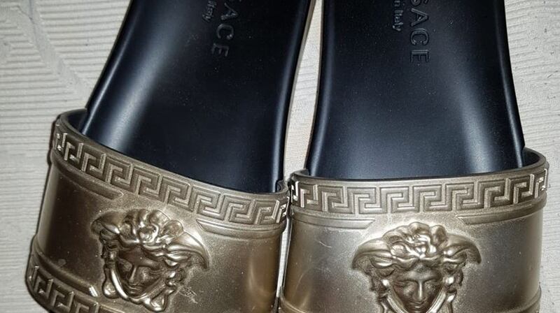 A selection of designer goods including a Gucci ‘manbag’ and a pair of Versace flip flops were among the items seized during the operation. Image: CAB
