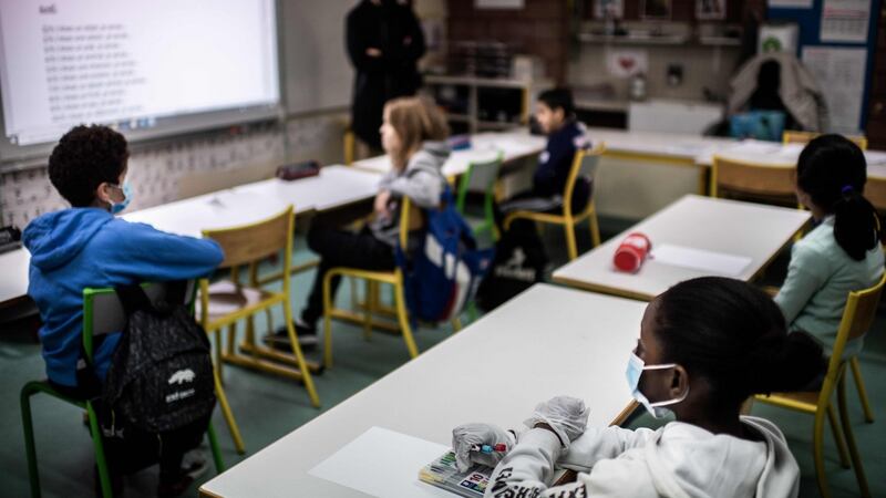 Pupils listen to their teacher at the Saint-Exupery school in the Paris’ suburb of La Courneuve as primary schools in France re-open this week after an almost two-month closure. Photograph: Martin Bureay/AFP
