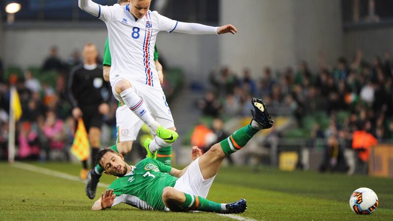 Conor Hourihane slide tackles Aron Sigurdarson. Photo: Aidan Crawley/EPA