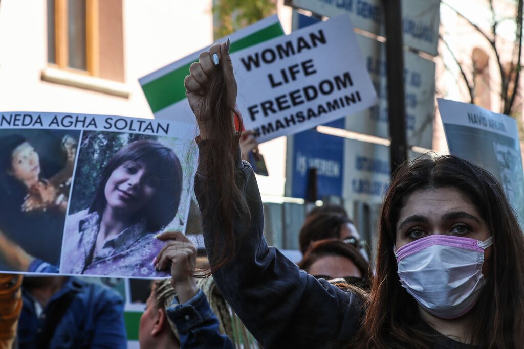 A woman holds up a lock of her hair she has cut off during protests outside the Iranian Consulate in Istanbul, Turkey on Monday. Photograph: Sedat Suna/EPA