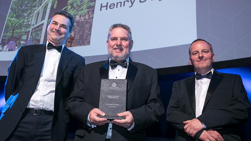 Patrick Devlin, General Manager Ireland, Zutec presents the Building of the Year - Office (Medium) award to Ronan Savage & Finghín Curraoin, Henry J Lyons.