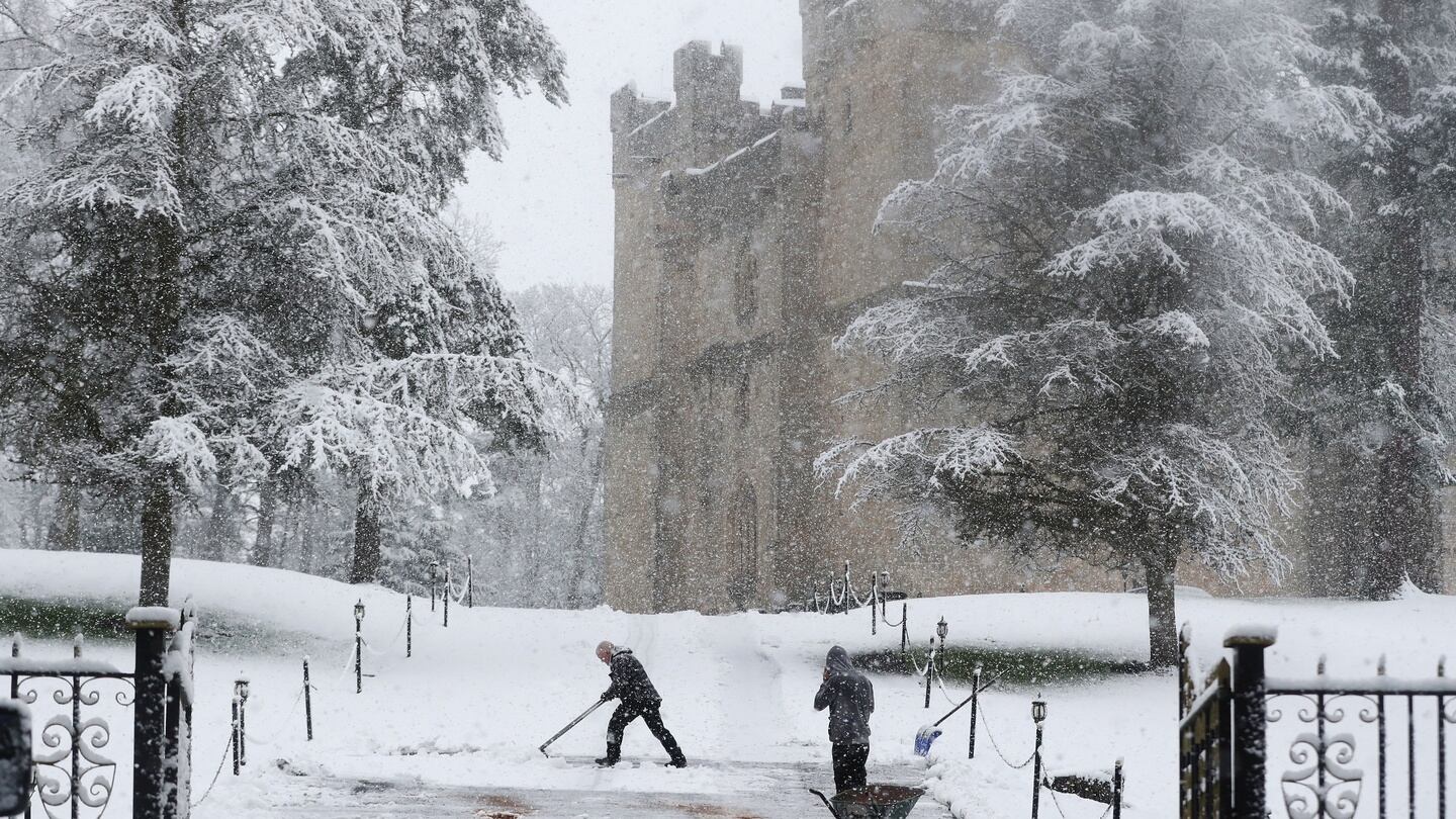A man clears the snow at Langley Castle in Northumberland on Wednesday. Photograph: Owen Humphreys/PA