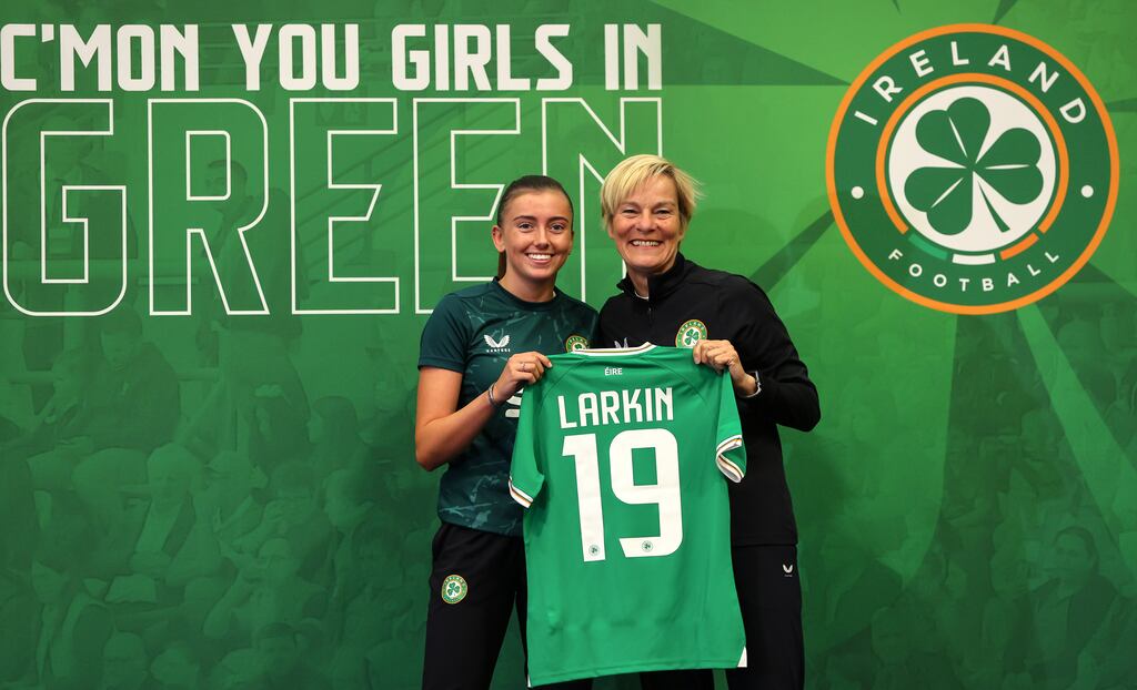 Ireland manager Vera Pauw presents Abbie Larkin with her World Cup jersey at a media day ay UCD on Thursday. Photograph: Ryan Byrne/Inpho