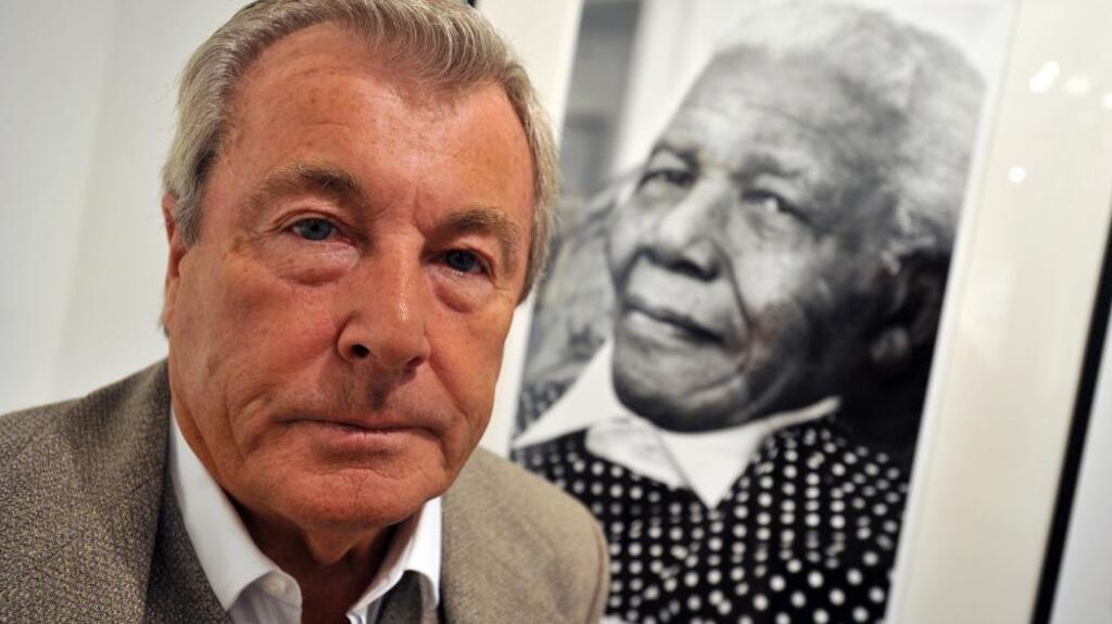 Terry O’Neill and his photograph of Nelson Mandela at 90 in 2009. Photograph: Daniel Deme/EPA