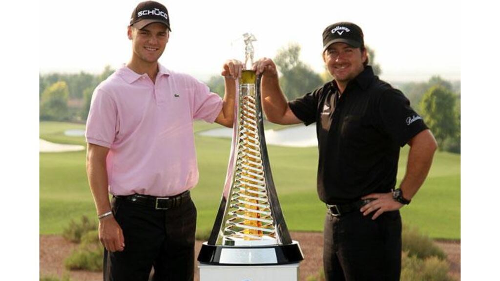 Martin Kaymer and Graeme McDowell pose with the Race to Dubai trophy during the Pro Am prior to the start of the Dubai World Championship on the Earth Course, Jumeirah Golf Estates in Dubai, United Arab Emirates. (Photograph: Ross Kinnaird/Getty Images)