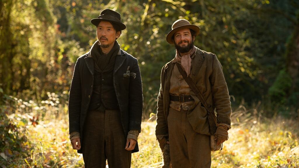 Orion Lee (left) as King-Lu and John Magaro (right) as ‘Cookie in director Kelly Reichardt’s First Cow, released by A24 Films. Photograph: Allyson Riggs