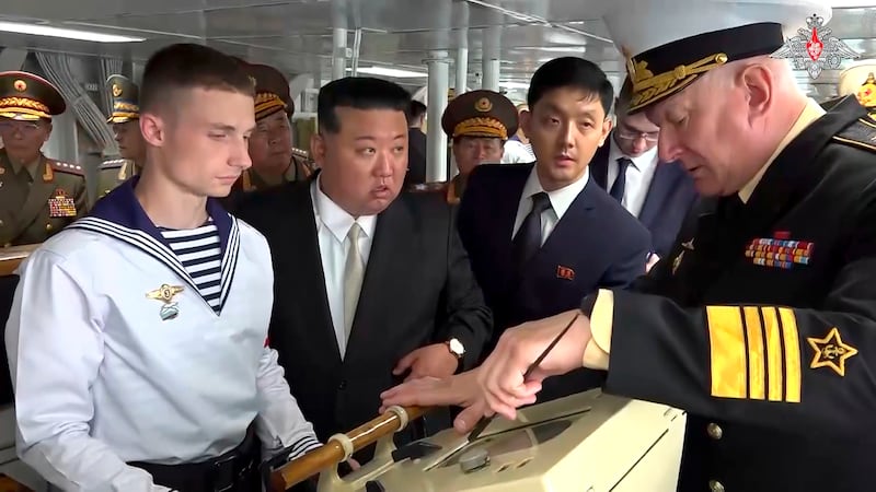 Kim Jong Un listens to Admiral Nikolai Yevmenov, commander-in-chief of the Russian navy while visiting the Admiral Shaposhnikov frigate. Photograph: Russian Defence Ministry Press Service via AP