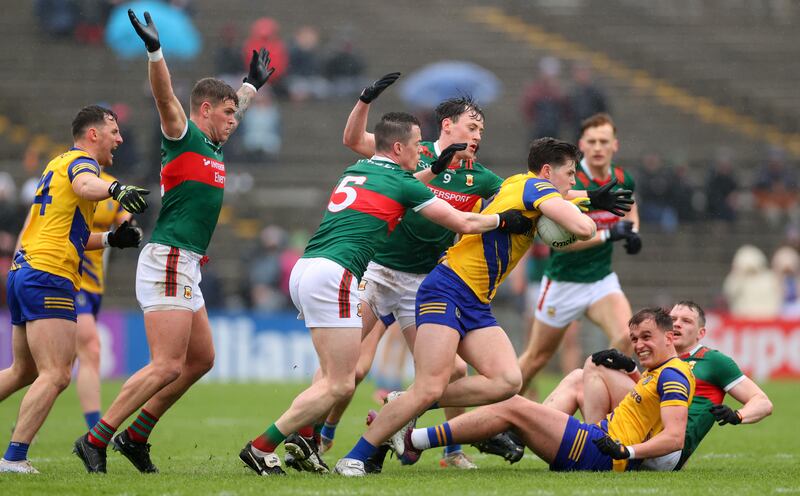Keith Doyle of Roscommon is challenged by Stephen Coen and Diarmuid O'Connor of Mayo during the Connacht SFC quarter-final at Hastings MacHale Park in Castlebar. Photograph: James Crombie/Inpho
