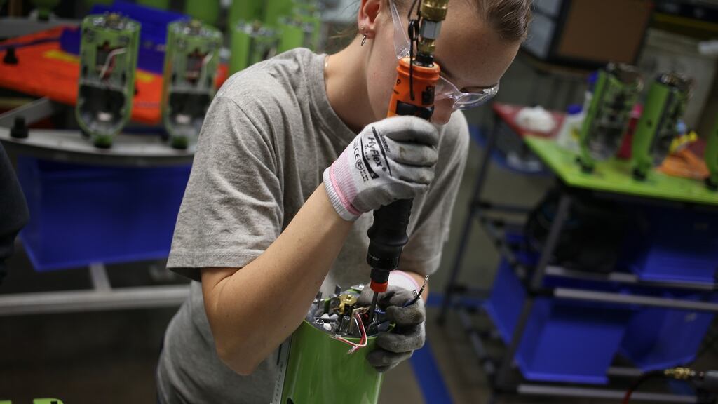 A worker assembles stand mixers on the production line at the Whirlpool . Photographer: Luke Sharrett/Bloomberg