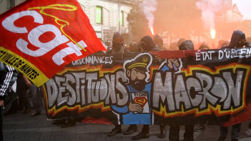Storm at home: French demonstrators hold an Oust Macron banner on Tuesday. Photograph: Stéphane Mahe/Reuters
