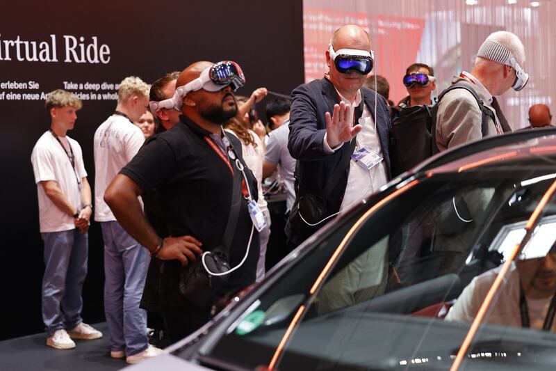 Visitors with VR glasses at the Mercedes stand at the Munich motor show