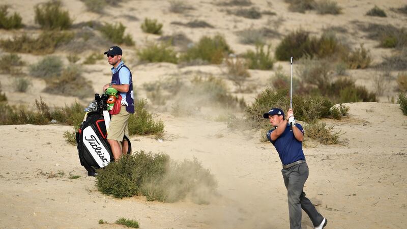 Paul Dunne plays his approach to the eighth from the desert. Photo: Ross Kinnaird/Getty Images