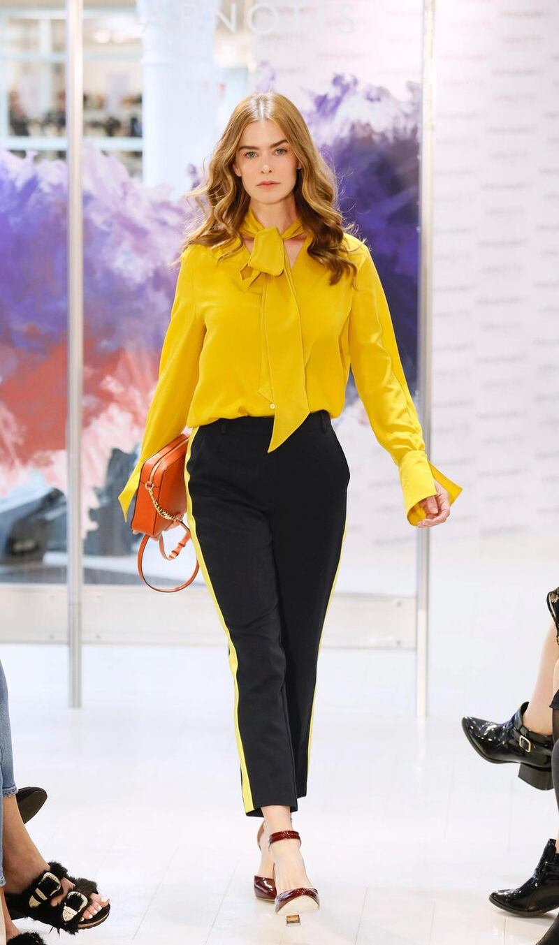 no fee if Arnotts mentioned in caption at the Arnotts Autumn Winter 2017 Womenswear Show-photo Kieran HarnettNiki Yellow silk blouse, Luisa Cerano, €310Navy with yellow stripe trousers, Millie Mackintosh, €100Orange crossbody bag, Michael Kors, €175Shoes by Vince Camuto