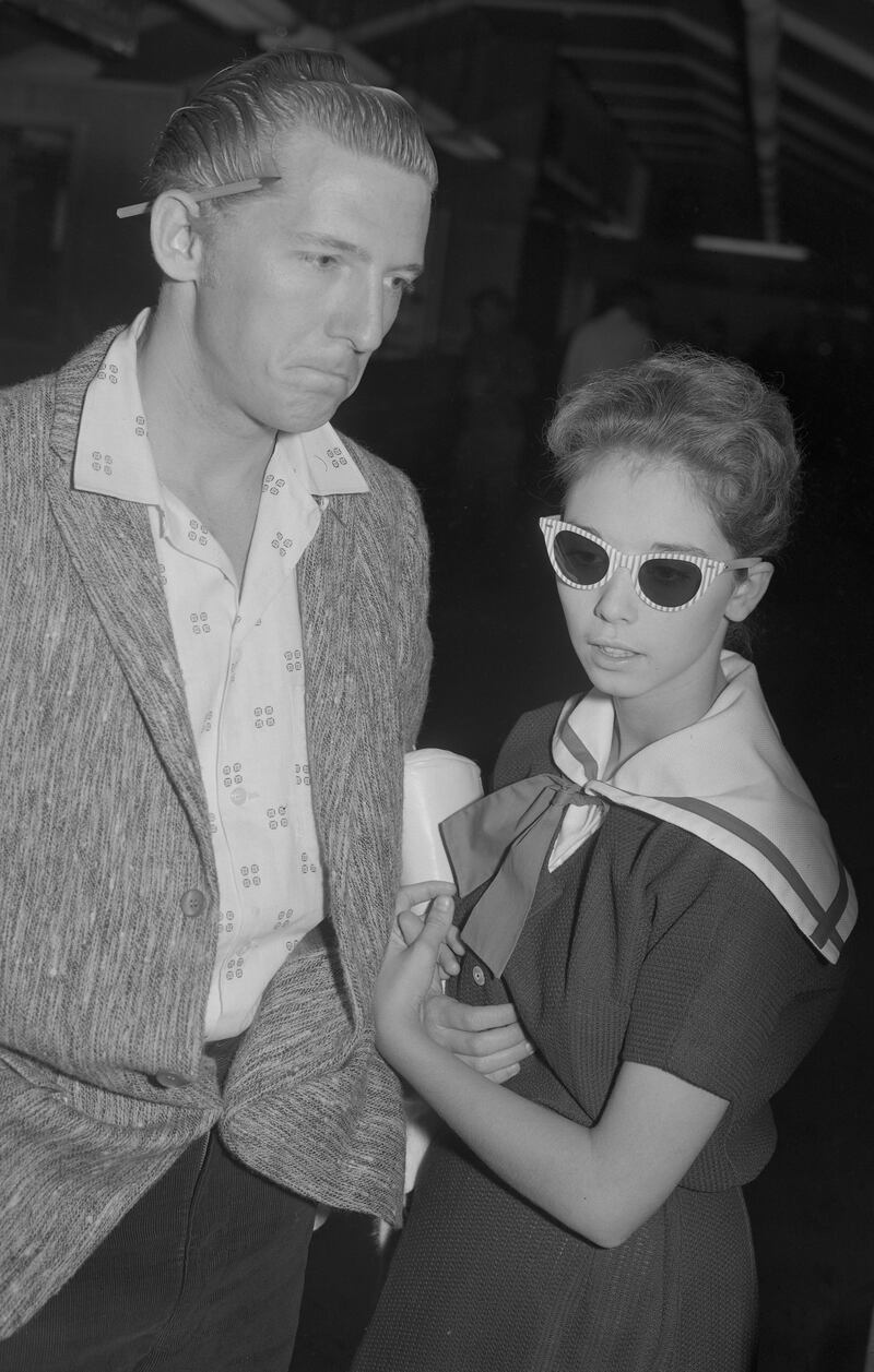 Jerry Lee Lewis and his 13-year-old bride, Myra, prepare to leave London on May 27th, 1958 after the cancellation of his UK tour. Photograph: PA