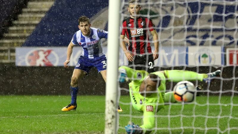 Wigan Athletic’s Callum Elder (left) scores his side’s third goal in the FA Cup third round replay against Bournemouth at the DW Stadium. Photograph: Martin Rickett/PA Wire