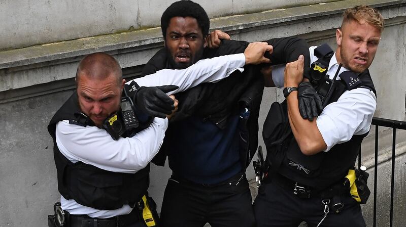 Police officers detain a protestor near the entrance to Downing Street, during an anti-racism demonstration in London. Photograph: Daniel Leal-Olivas/AFP via Getty Images
