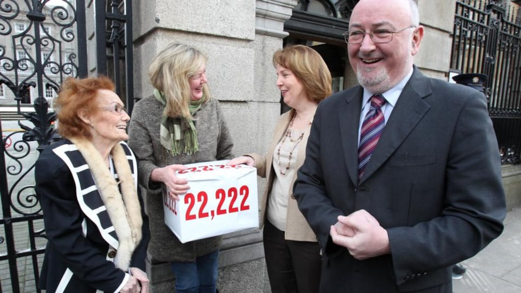 Mairin O'Moore and her daughter Eilin O'Moore from the Survivors of Symphysiotomy group present a petition to Senator Jillian Van Turnout and Sinn Fein’s Caoimhghin O Caolain from the all party support group at Leinster House in Dublin. Photograph: Niall Carson/PA Wire
