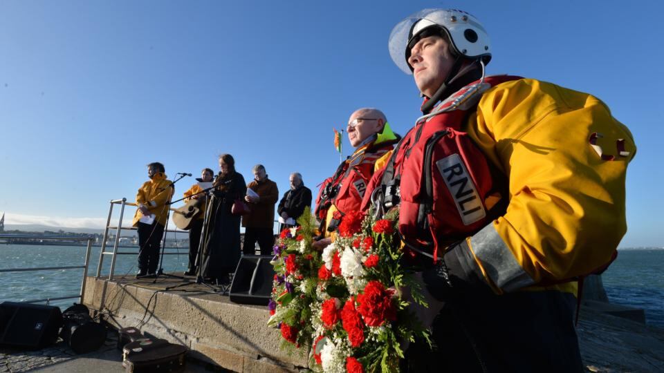 RNLI Dun Laoghaire crew members Eamon O’Leary and Daragh Brady taking part in a ceremony on the East Pier to remember the 15 volunteers that died on service in 1895 on Christmas Eve. Photograph: Alan Betson / The Irish Times