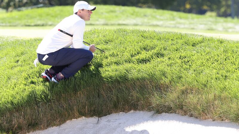 McIlroy waits to putt on the first green. Photo: Jamie Squire/Getty Images