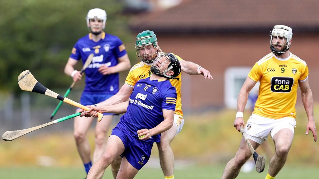 Clare’s David Reidy is tackled by Antrim’s Niall McKenna. Photograph: Laszlo Geczo/Inpho