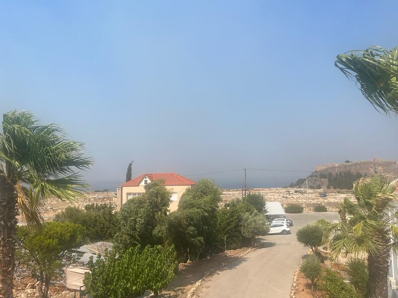 Smoke in the distance at Lindos in Greece where the Mc Manus family's hotel is located.