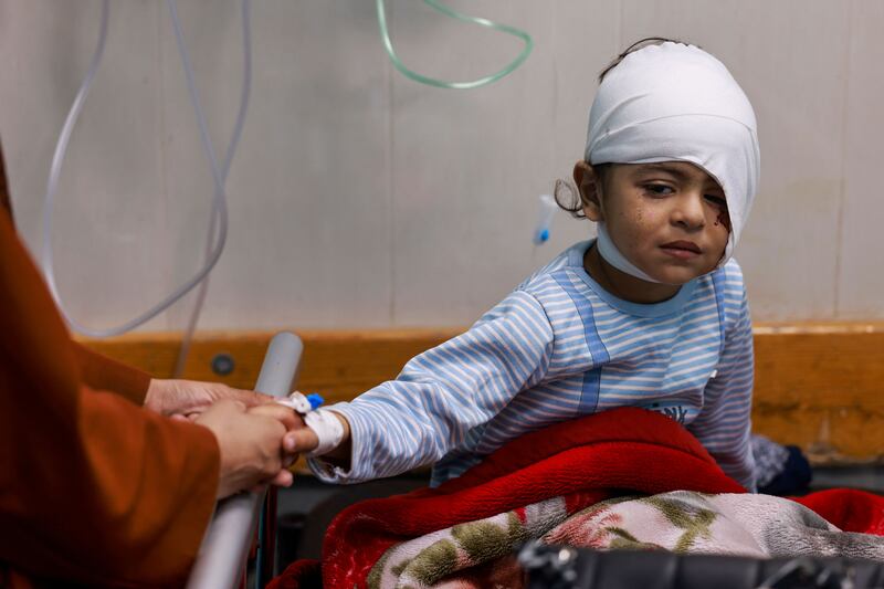 A wounded Palestinian child from the Jabalia refugee camp sits on a bed after being transferred from the Indonesian Hospital in the north of Gaza to the Nasser Hospital in Khan Younis, in the south, on November 21st. Photograph: Mohammed Abed/AFP via Getty Images
