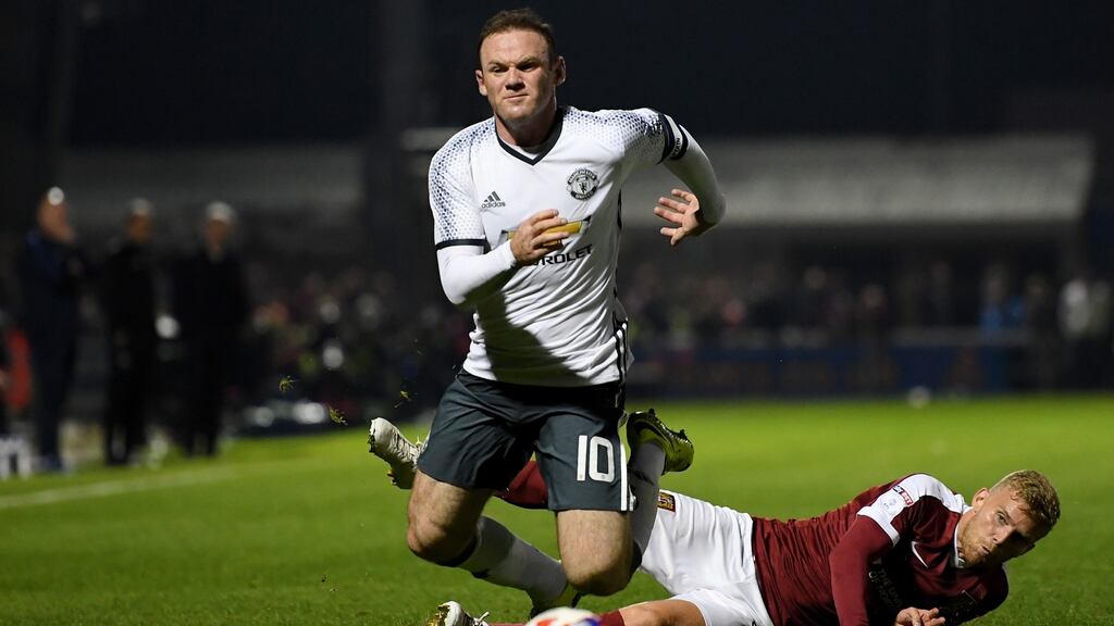 Wayne Rooney of Manchester United is challenged by Alfie Potter of Northampton Town during the EFL Cup Third Round match at Sixfields. Photo: Laurence Griffiths/Getty Images