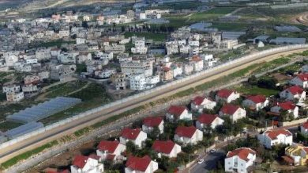 A section of the Israeli wall on the West Bank separating the Palestinian town of Tulkarm (left) from the Israeli village of Bat Hefer (right). Photograph: Reuters