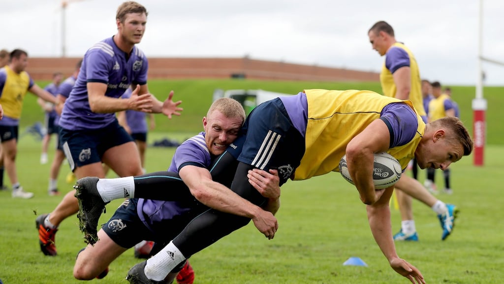 Keith Earls tackles Cian Bohane during Munster squad training at University of Limerick yesterday. Photograph: Ryan Byrne/Inpho.