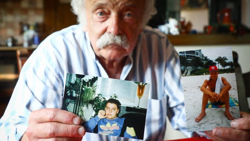 Andrzej Wasikiewicz holds photographs of his son, Michal, at his home in Wloclawek, Poland. Photograph: Beata Zawrzel for The Irish Times