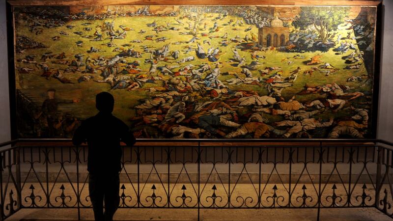 A young visitor looks at a painting depicting the Amritsar Massare at Jallianwala Bagh in Amritsar. Photograph: Narinder Nanu/AFP/Getty