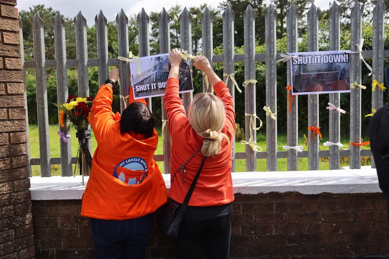 Protesters at Shannonside Foods tie ribbons on the gates of the company. Photograph: Dara Mac Dónaill