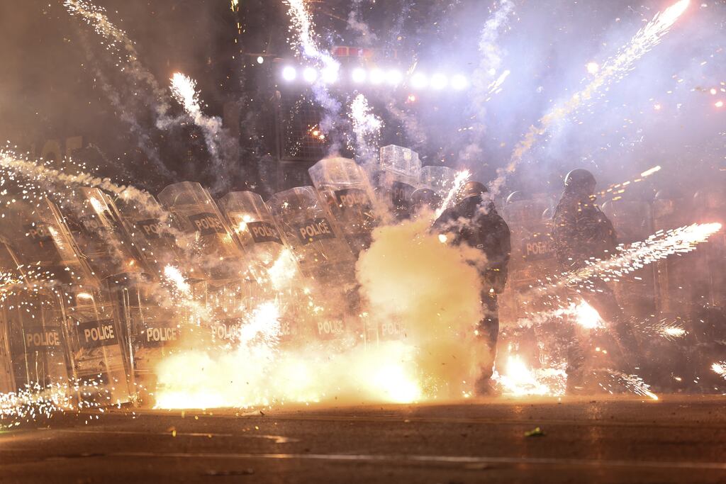 Fireworks thrown by protesters strike members of the police during the fifth straight night of demonstrations in Tbilisi against the Georgian government's postponement of EU accession talks. Photograph: Giorgi Arjevanidze/AFP via Getty Images