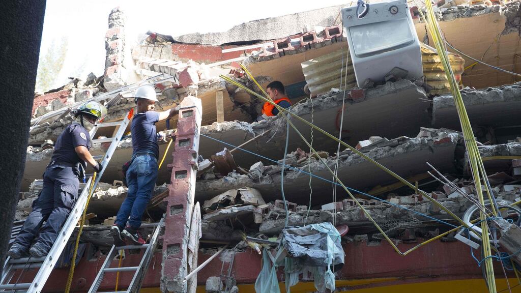 Rescuers search for survivors after the Mexico earthquake. Photograph: AFP/Carlos Ramirez