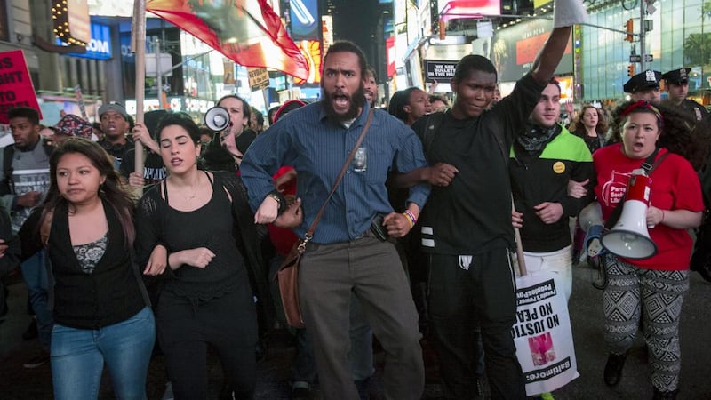Protesters march through Times Square during a demonstration calling for social, economic and racial justice. The demonstration was being held to support Baltimore’s protest against police brutality following the April 19th death of Freddie Gray in police custody. Photograph: Andrew Kelly/Reuters