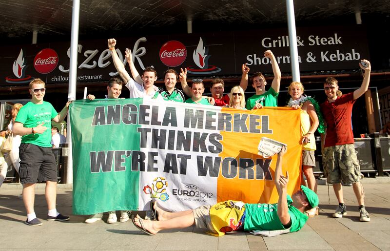 Irish fans with the Angela Merkel flag during Euros 2012. Photograph:
James Crombie/Inpho